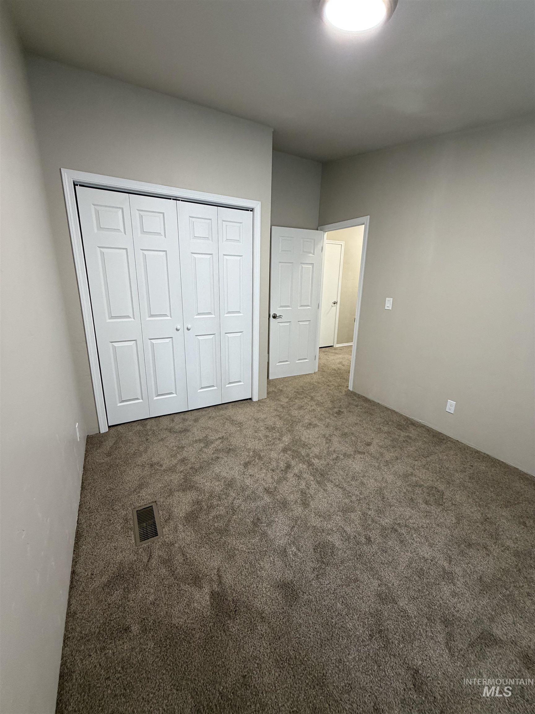 815 East Liberty Street Weiser, ID 83672 - Photo 17 of 25 Unfurnished bedroom featuring carpet floors and a closet