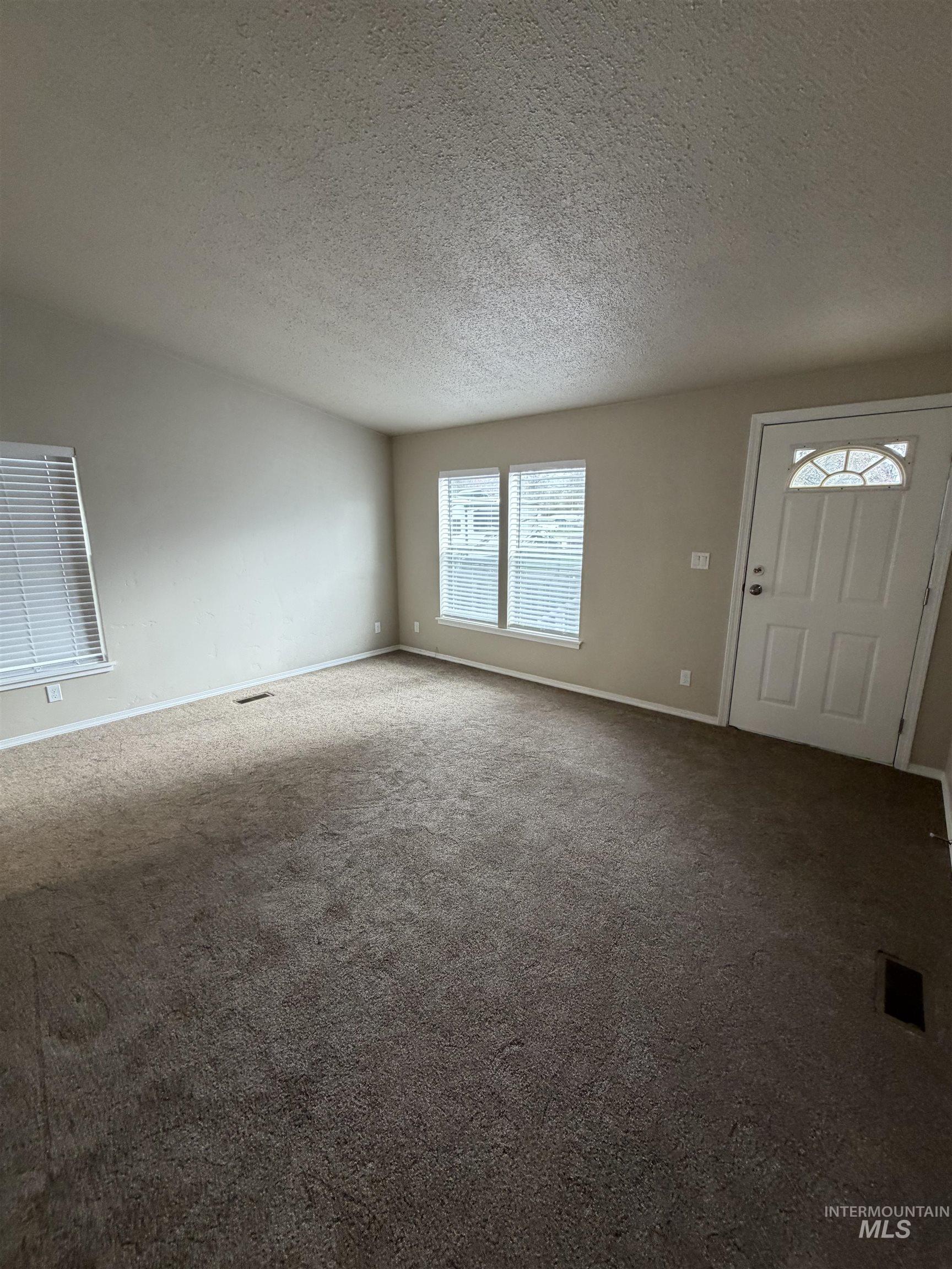 815 East Liberty Street Weiser, ID 83672 - Photo 2 of 25 Foyer with carpet and a textured ceiling