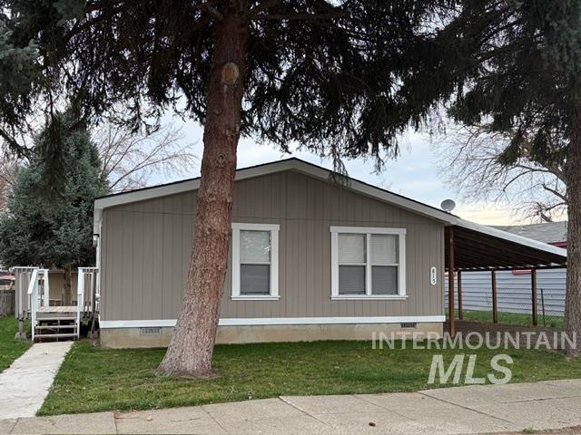 815 East Liberty Street Weiser, ID 83672 - Photo 21 of 25 View of home's exterior featuring crawl space, an attached carport, a yard, and a deck