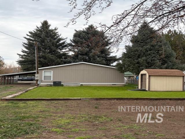 815 East Liberty Street Weiser, ID 83672 - Photo 22 of 25 View of grassy yard featuring a storage unit
