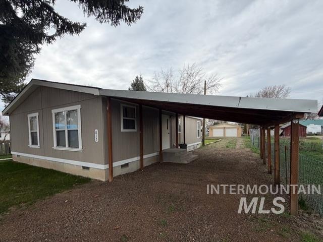 815 East Liberty Street Weiser, ID 83672 - Photo 23 of 25 View of side of home with crawl space, a carport, and dirt driveway