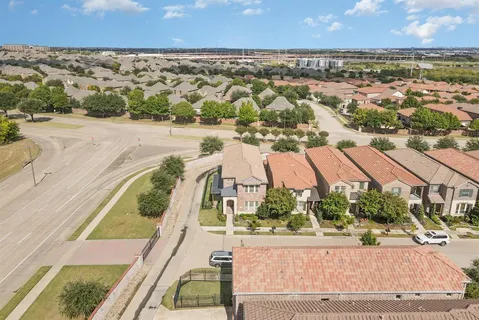 an aerial view of residential houses with outdoor space and swimming pool