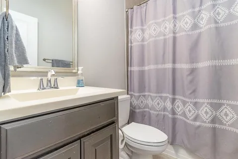a living room with furniture wooden floor and a view of kitchen