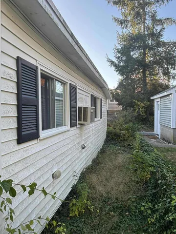 a view of house with backyard