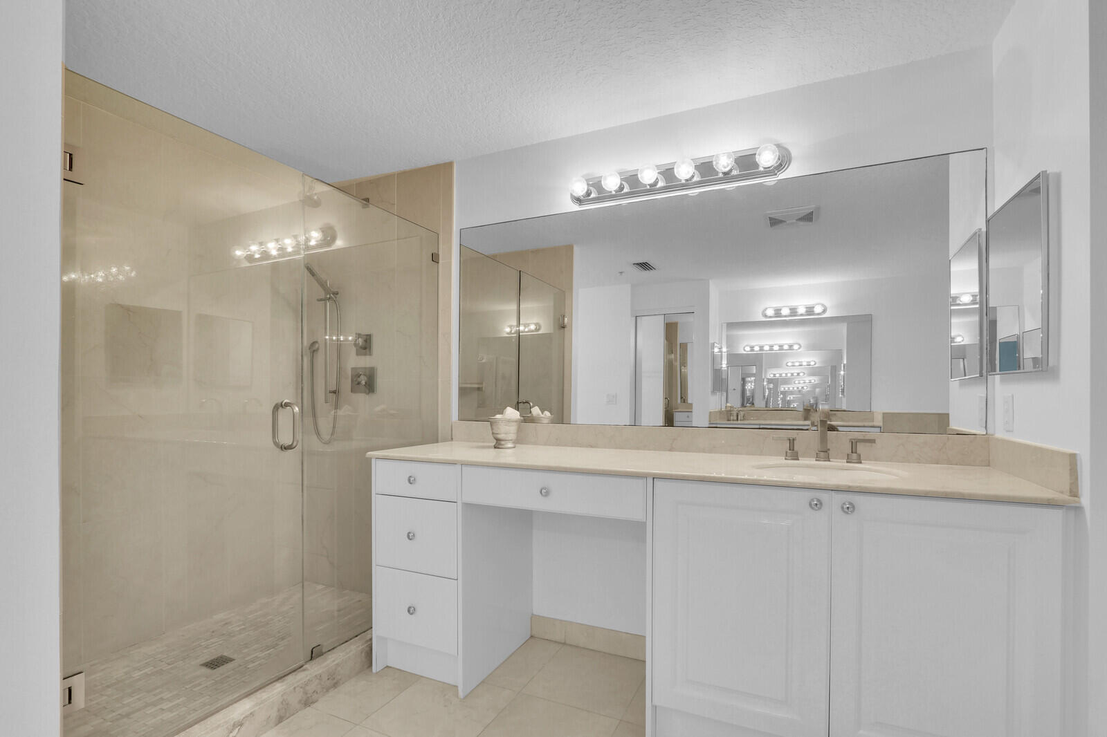 700 Ocean Royale, Unit 202 Juno Beach, FL 33408 - Photo 16 of 34 a bathroom with a sink mirror and a shower