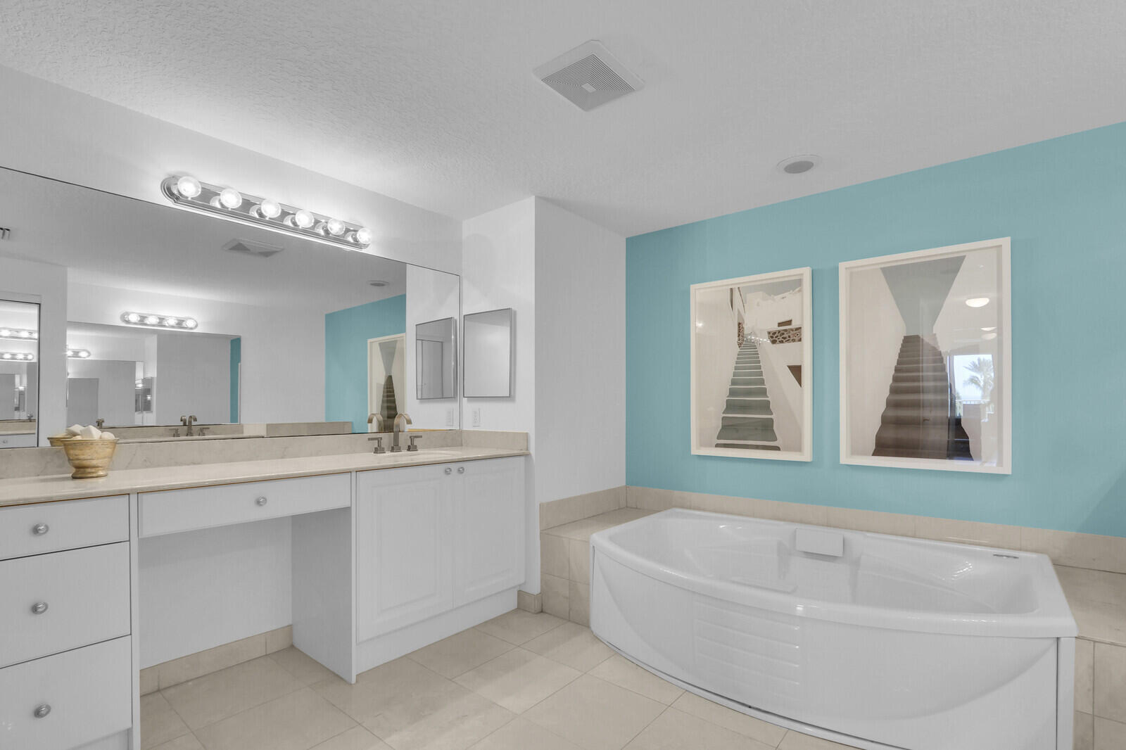 700 Ocean Royale, Unit 202 Juno Beach, FL 33408 - Photo 17 of 34 a bathroom with a tub a sink and mirror