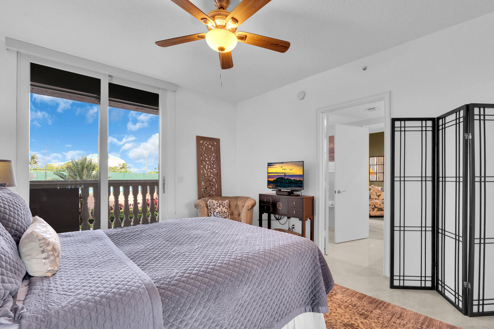 700 Ocean Royale, Unit 202 Juno Beach, FL 33408 - Photo 19 of 34 a bedroom with a bed dresser and a large window