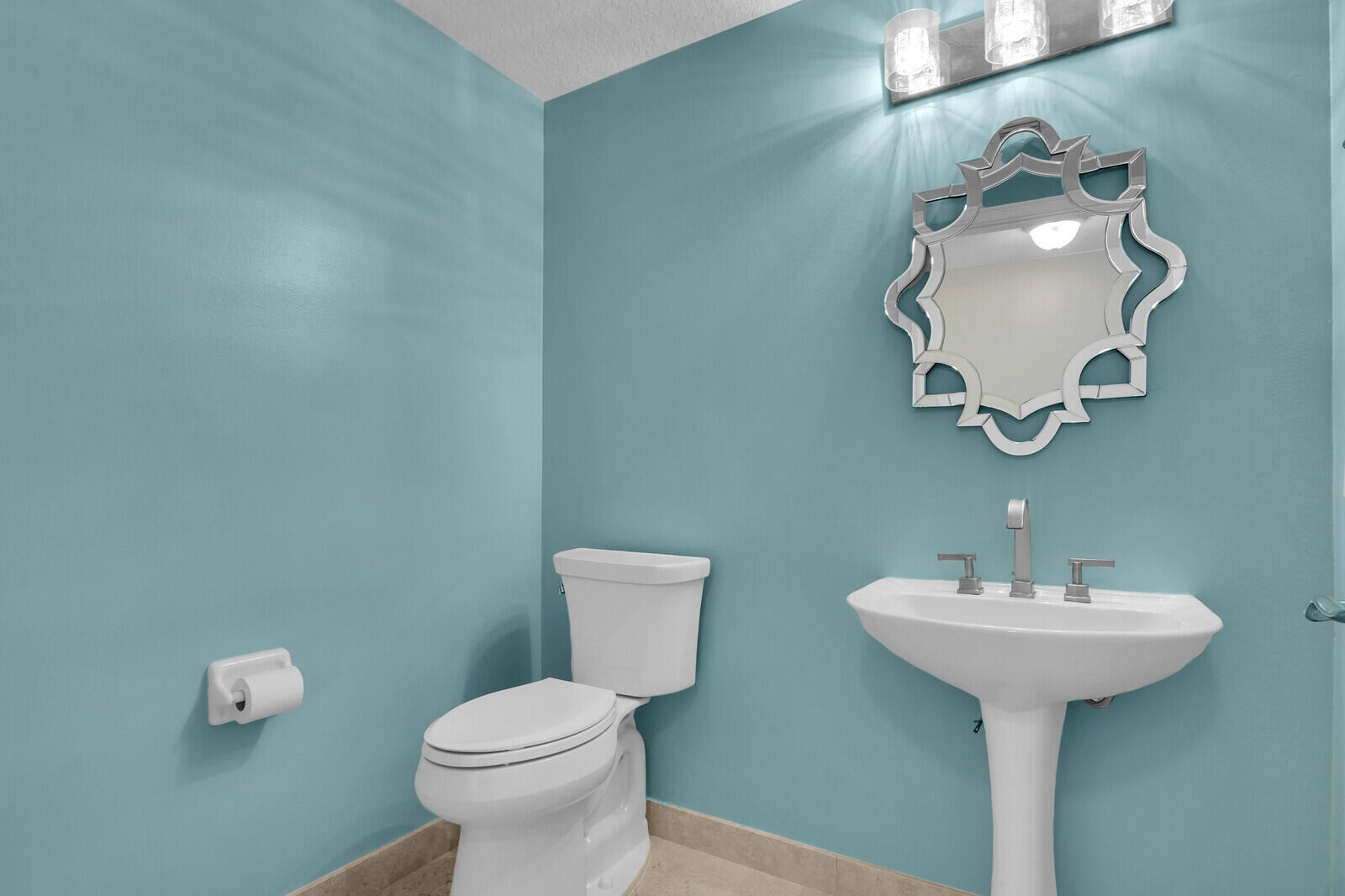 700 Ocean Royale, Unit 202 Juno Beach, FL 33408 - Photo 23 of 34 a bathroom with a toilet sink and mirror