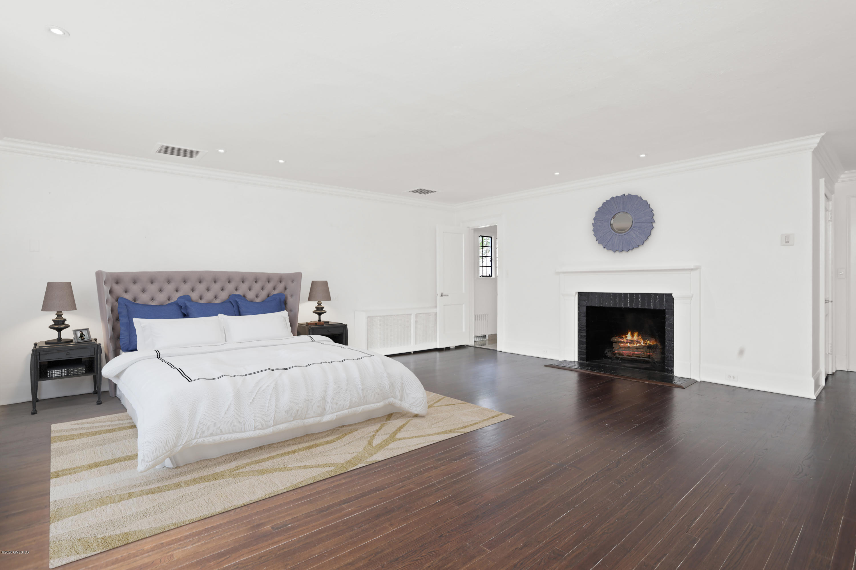 558 Lake Avenue Greenwich, CT 06830 - Photo 14 of 28 a bedroom with a bed and a fireplace