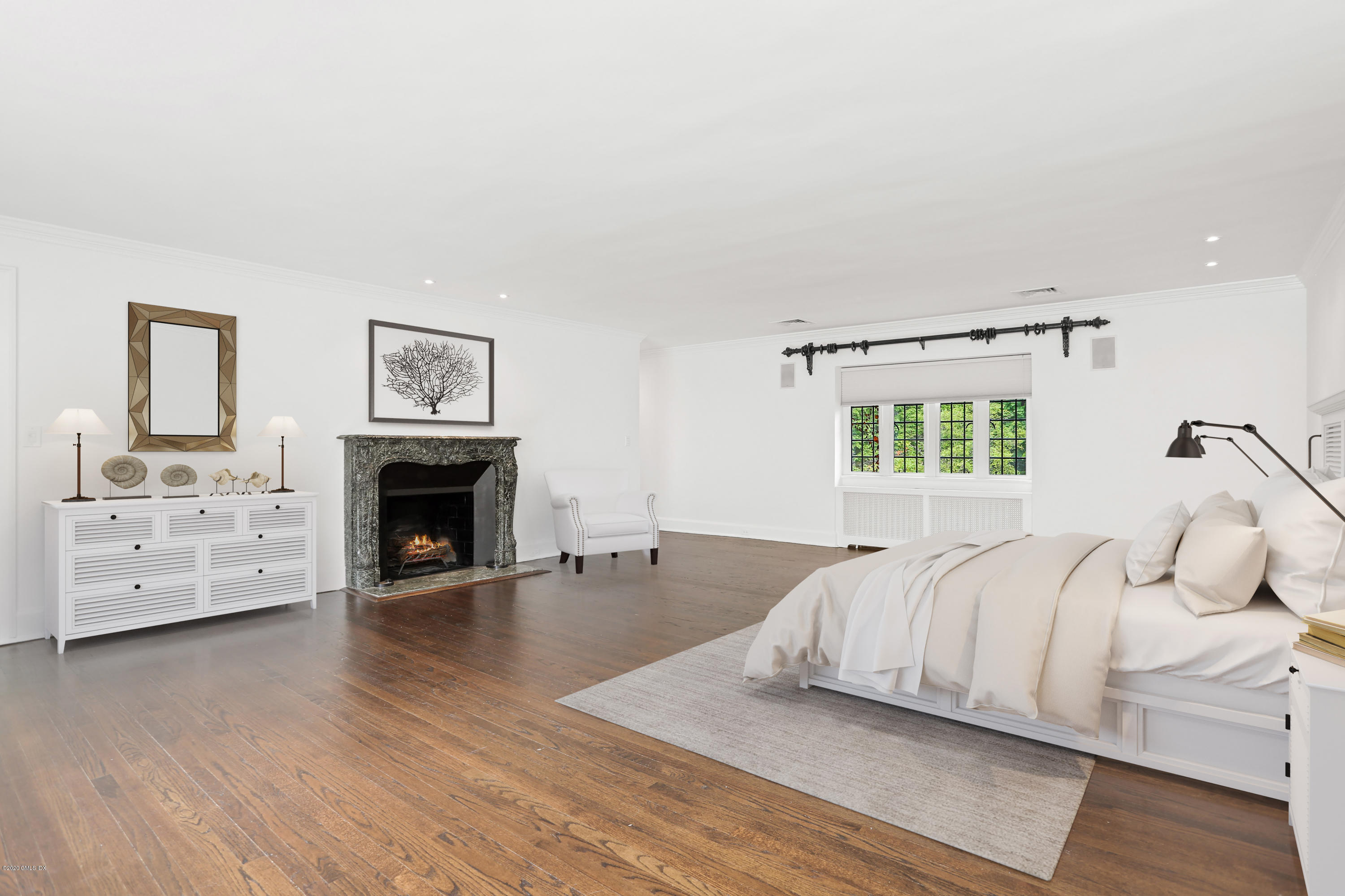 558 Lake Avenue Greenwich, CT 06830 - Photo 17 of 28 a spacious bedroom with a bed and a fireplace