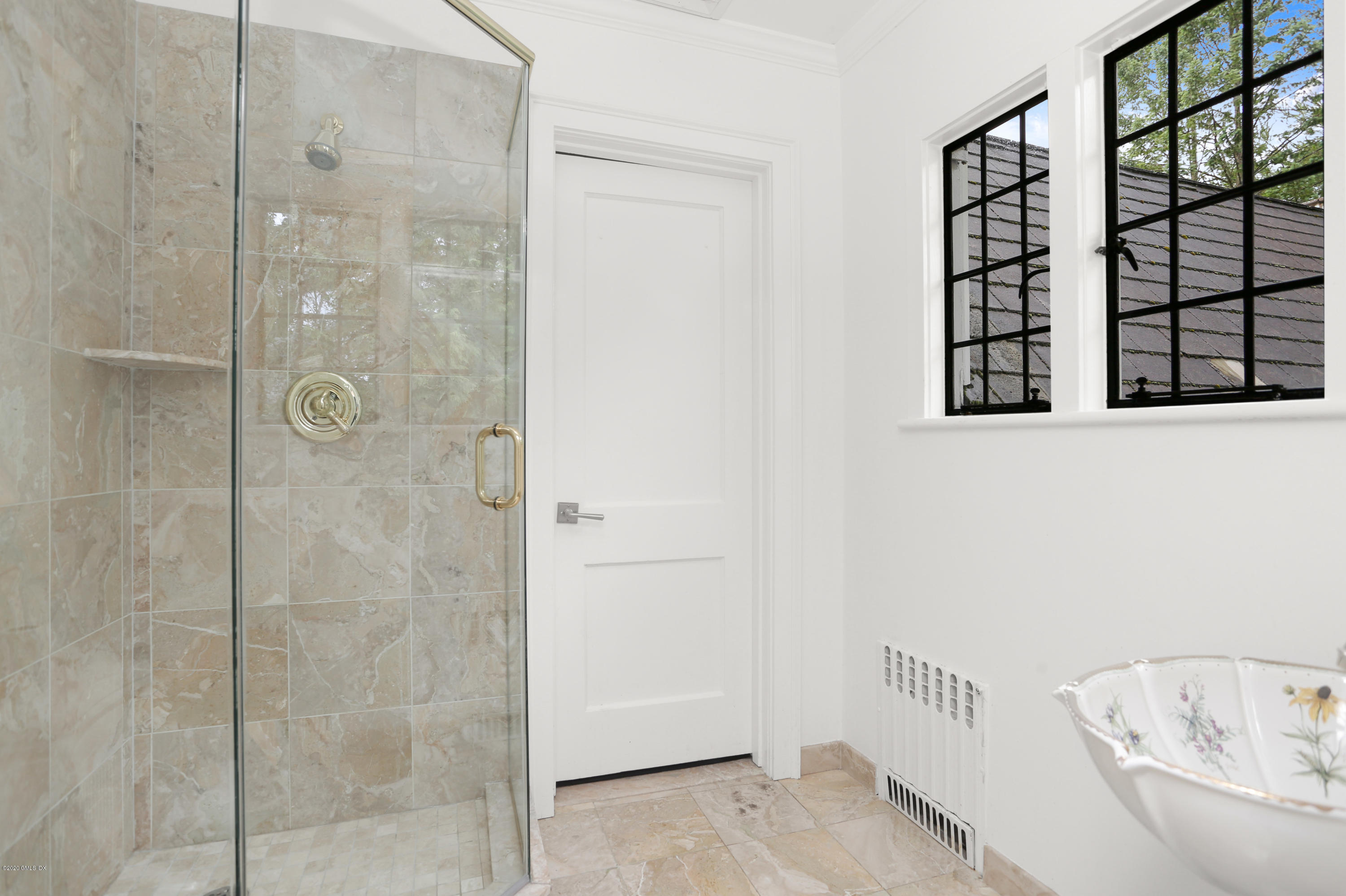 558 Lake Avenue Greenwich, CT 06830 - Photo 18 of 28 a bathroom with a bathtub and shower