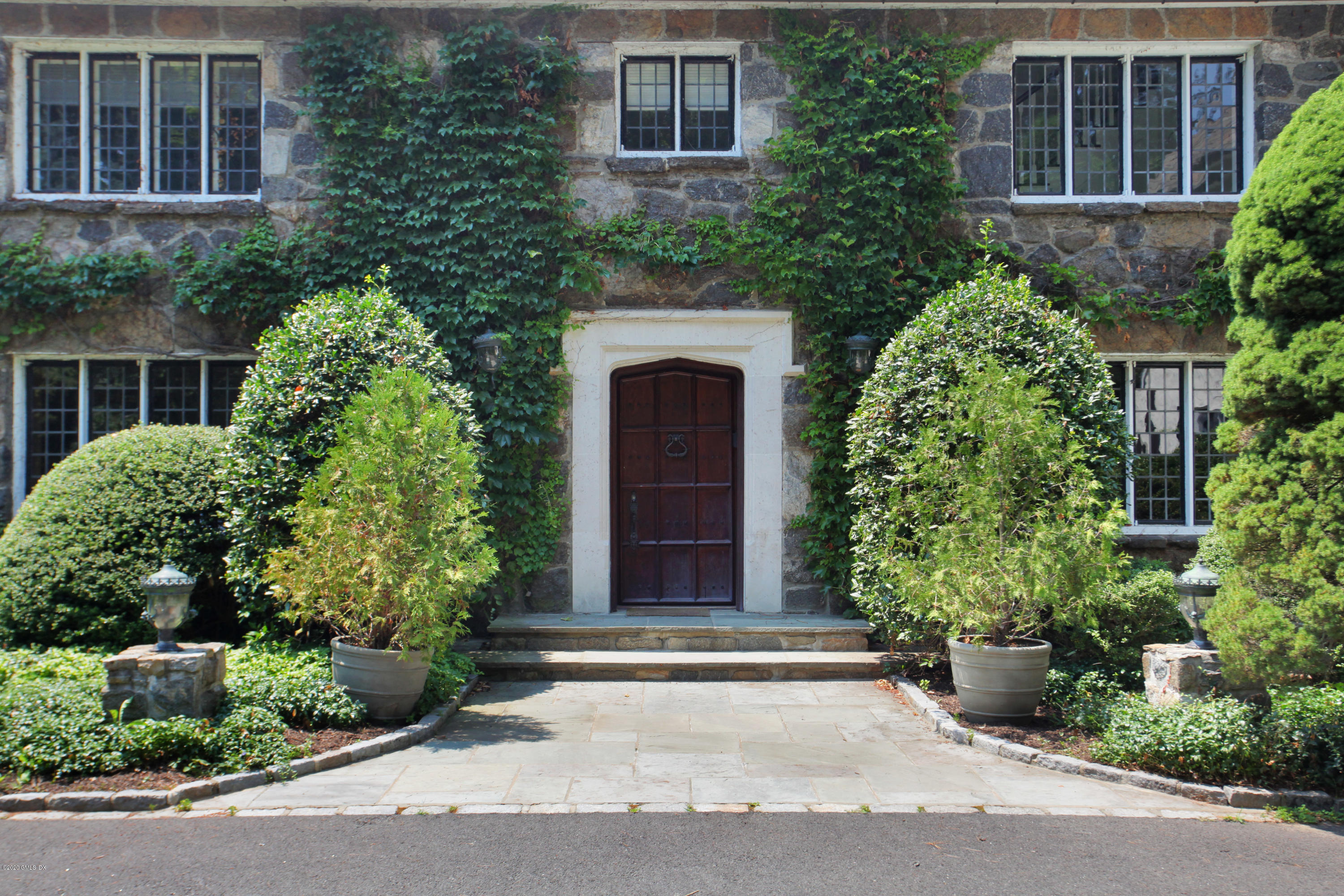 558 Lake Avenue Greenwich, CT 06830 - Photo 4 of 28 front view of a house with potted plants