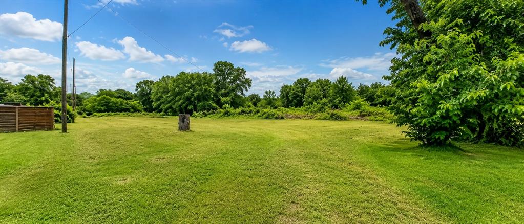 504 North Hampton Road DeSoto, TX 75115 - Photo 5 of 11 Expansive green lawn with scattered trees and natural vegetation in the background