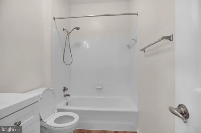 a bathroom with a shower a toilet and a shower