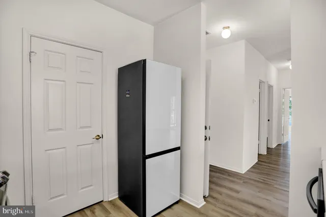 a view of hallway with wooden floor
