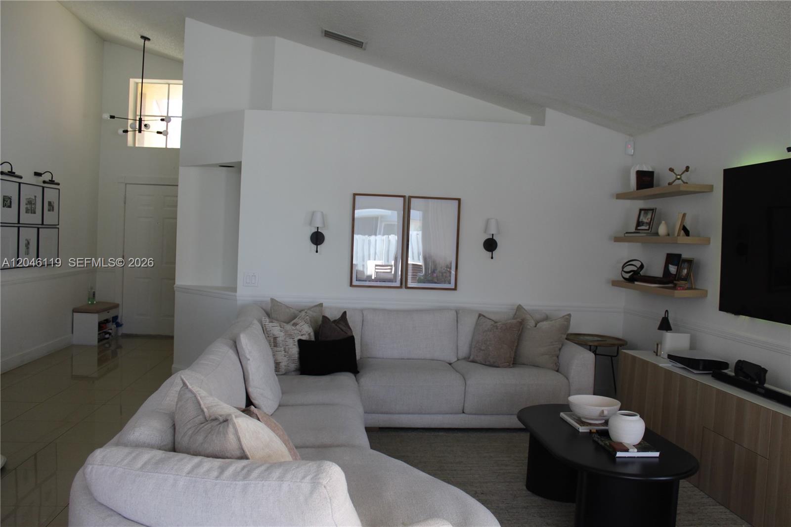 312 Bridgeton Road Weston, FL 33326 - Photo 5 of 13 a living room with furniture and a flat screen tv