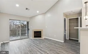 an empty room with wooden floor and a fireplace