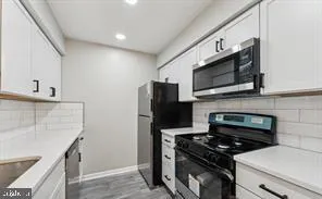 a kitchen with a stove and a microwave