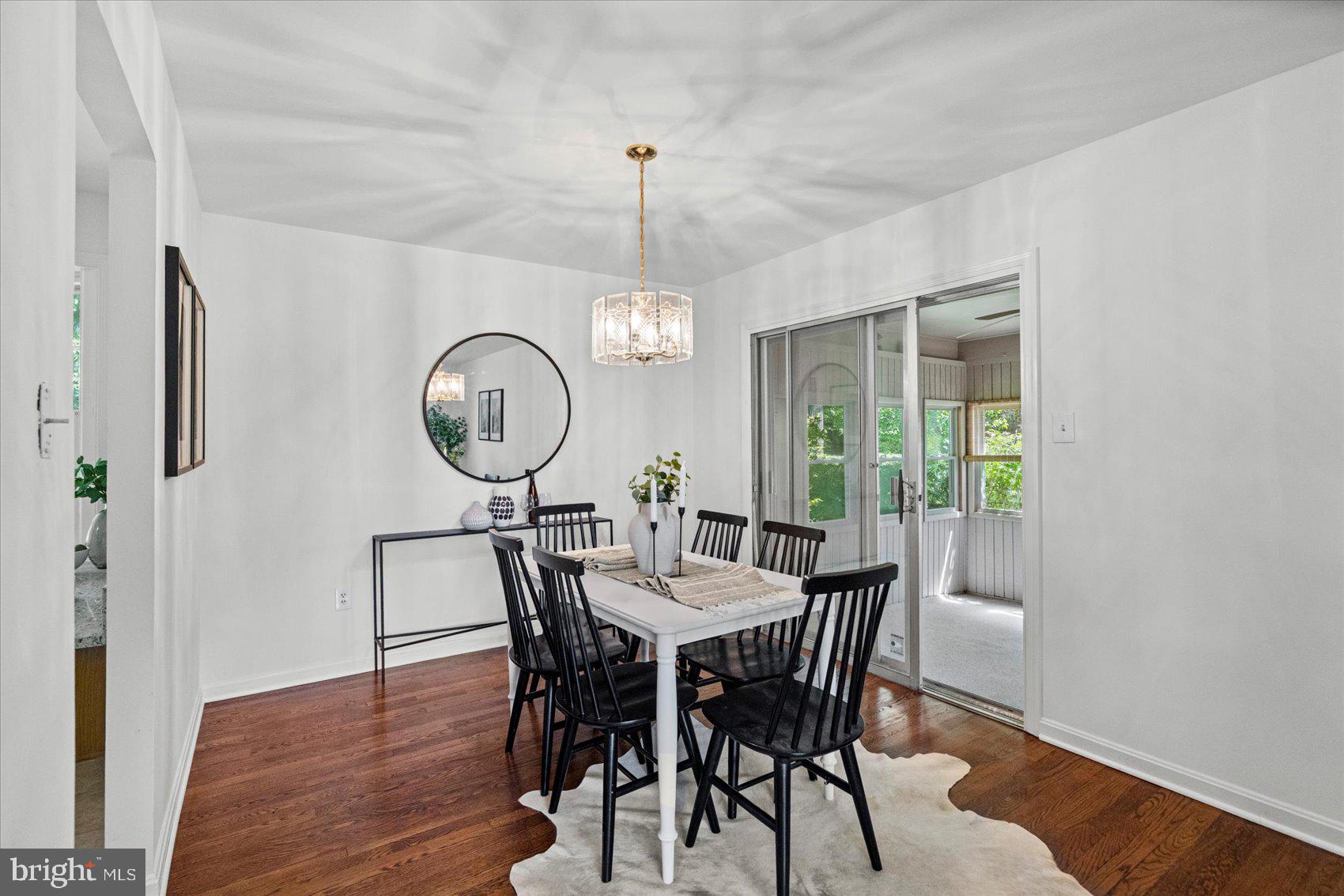 2300 Musgrove Road Silver Spring, MD 20904 - Photo 20 of 41 a dining room with furniture a rug a potted plant and a chandelier