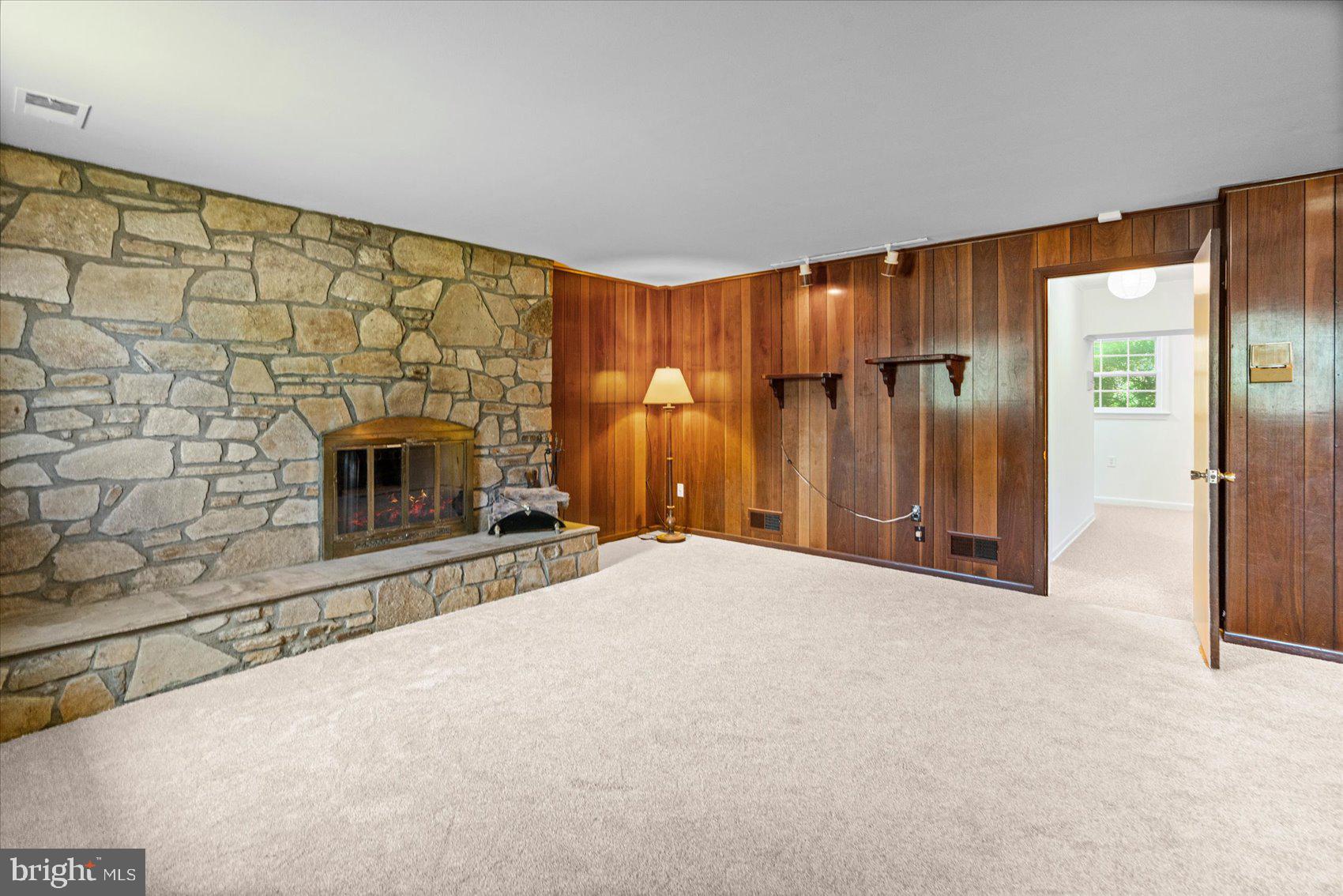 2300 Musgrove Road Silver Spring, MD 20904 - Photo 30 of 41 a view of an empty room with wooden floor and a fireplace
