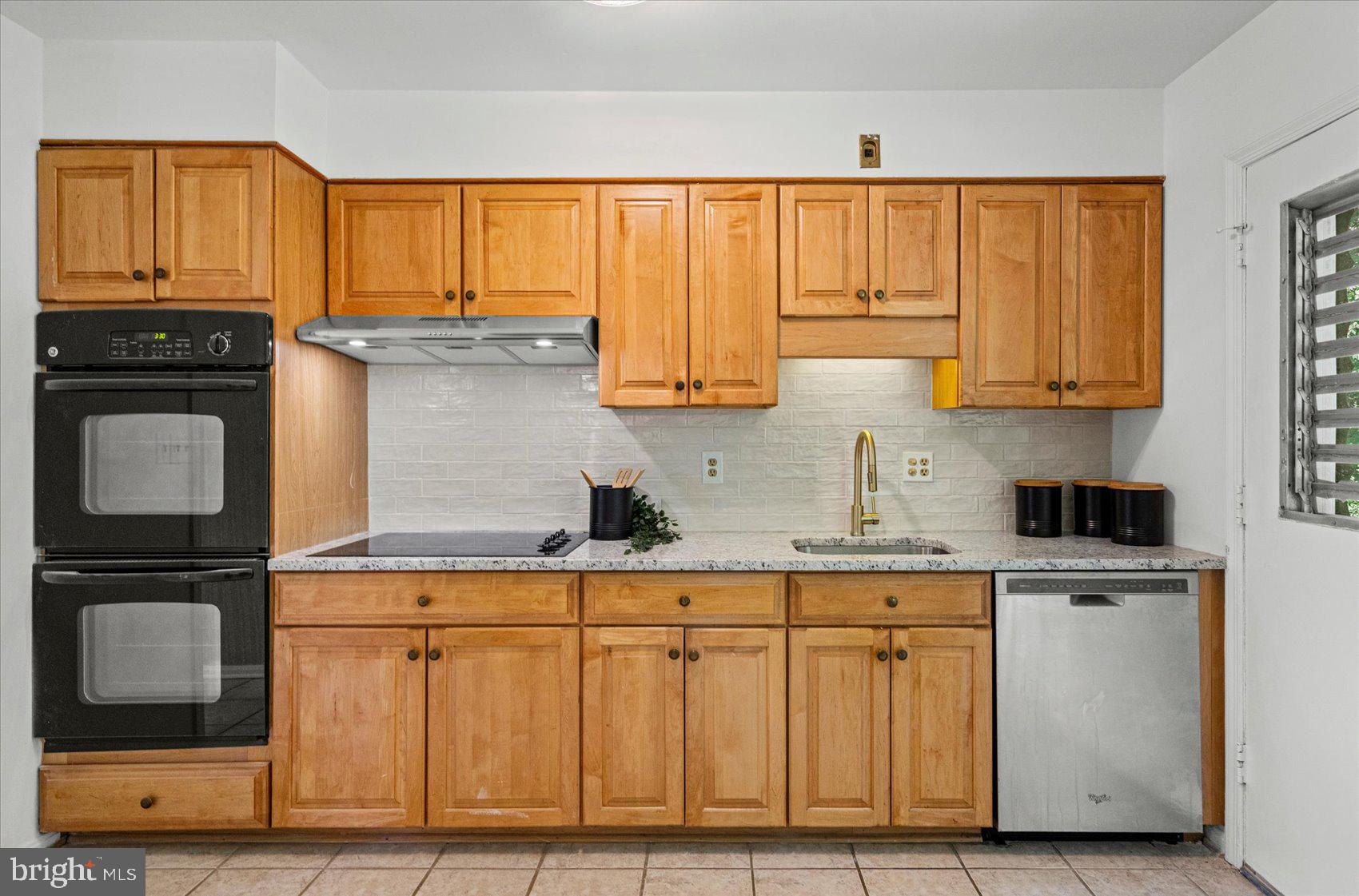 2300 Musgrove Road Silver Spring, MD 20904 - Photo 6 of 41 a kitchen with granite countertop a stove top oven cabinetry