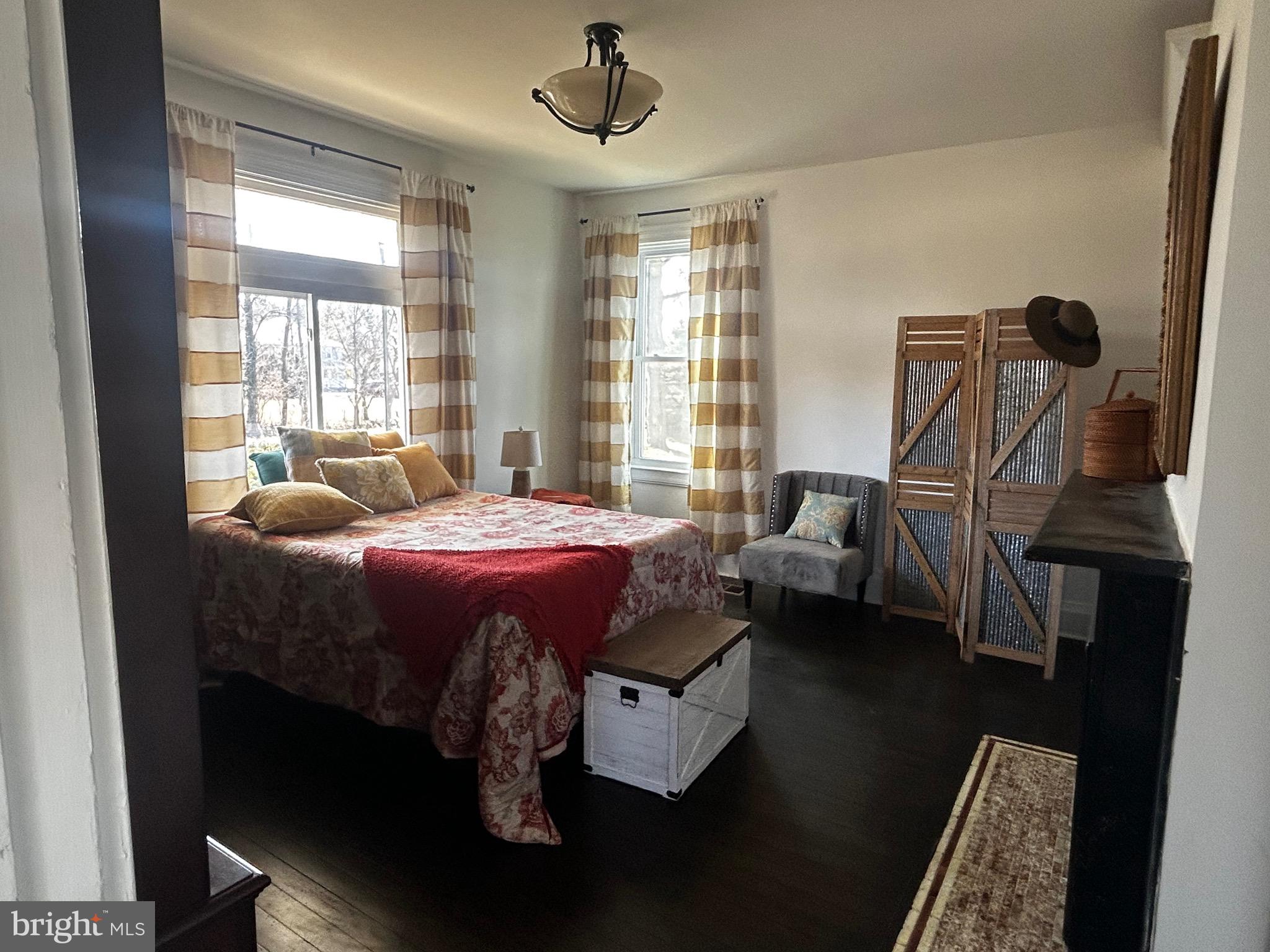 129 Church Street Summit Point, WV 25446 - Photo 36 of 91 a bedroom with a bed wooden floor and window