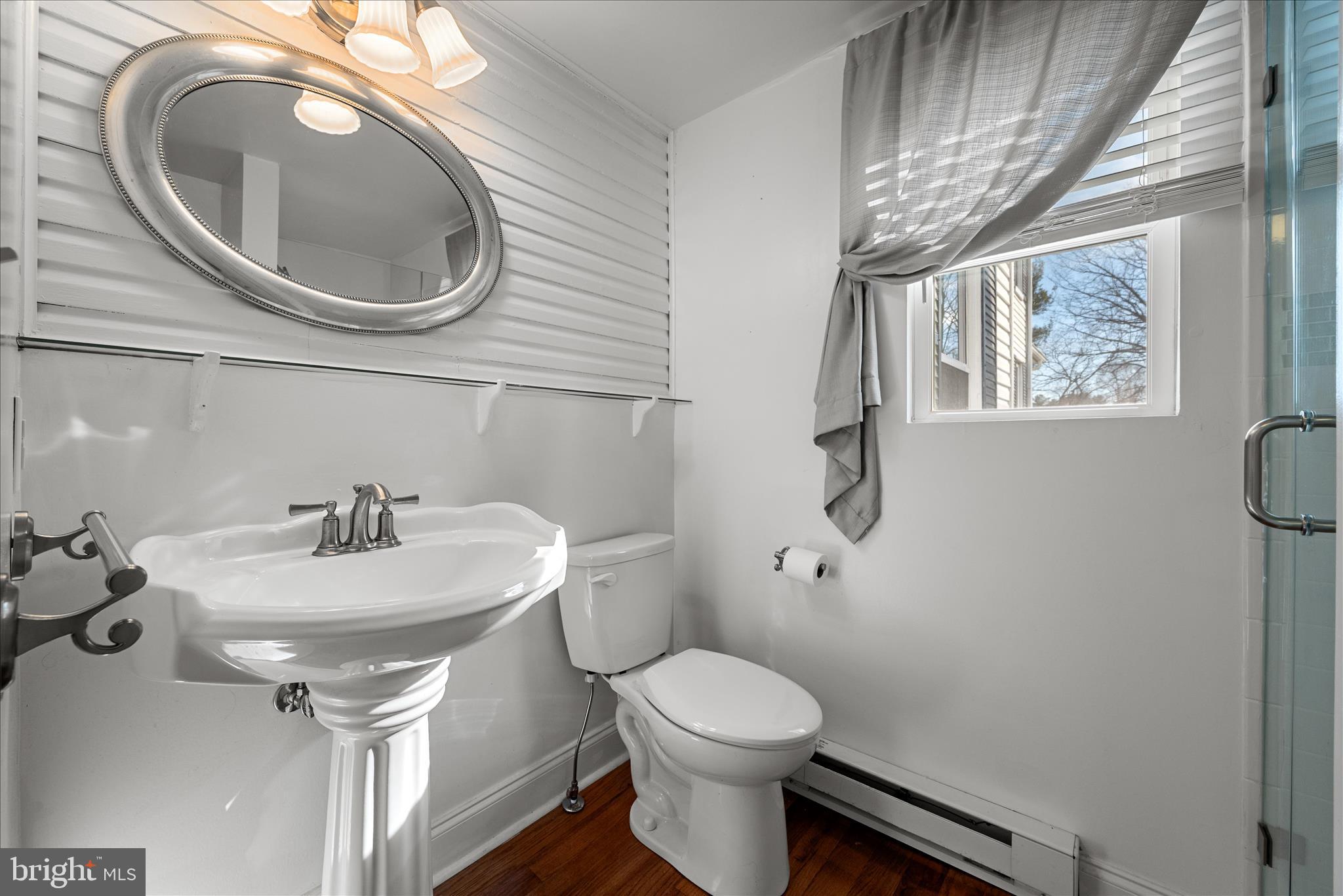 129 Church Street Summit Point, WV 25446 - Photo 46 of 81 a bathroom with a toilet a sink and mirror