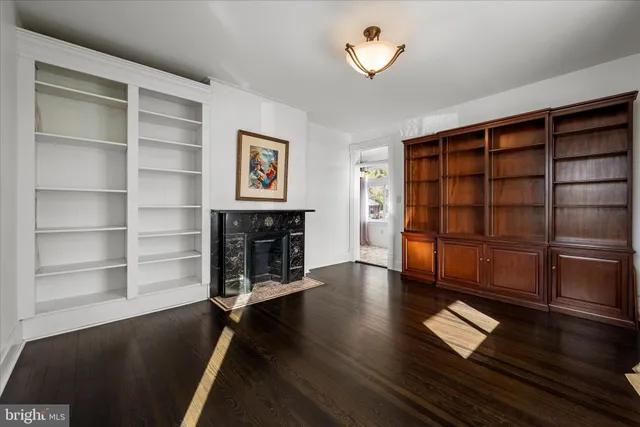 a kitchen with granite countertop a stove a sink a refrigerator and wooden cabinets