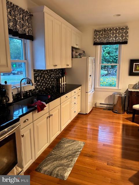 129 Church Street Summit Point, WV 25446 - Photo 75 of 81 a kitchen with granite countertop a stove a sink a refrigerator and wooden cabinets