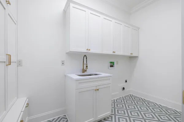 a view of a kitchen with white cabinets