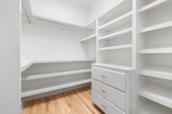 a view of walk in closet with empty racks