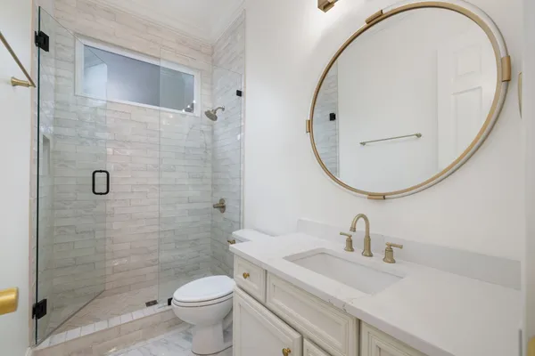 a bathroom with a sink a toilet and a mirror