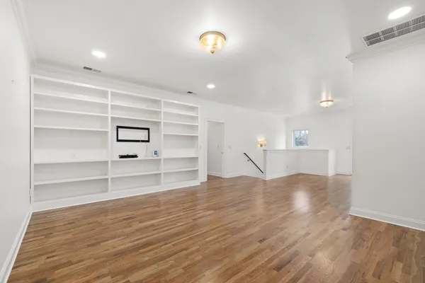 a view of a room with wooden floor and closet