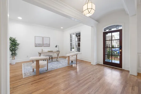 a view of a livingroom with furniture wooden floor and a window