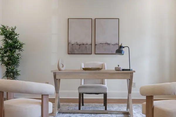 a room with a table chairs and wooden floor