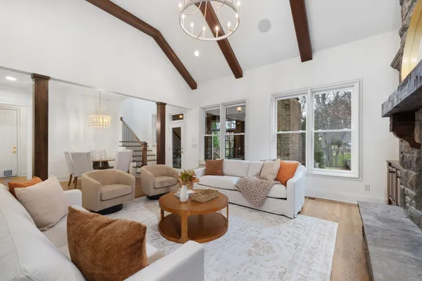 a living room with furniture and large windows