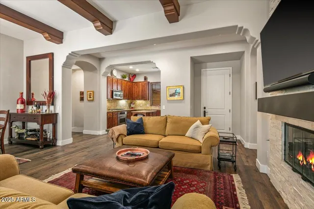 a kitchen with granite countertop wooden floors wooden cabinets and stainless steel appliances
