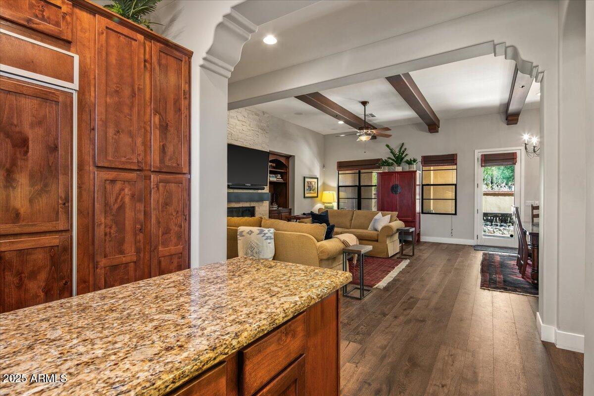 20704 North 90th Place, Unit 1004 Scottsdale, AZ 85255 - Photo 15 of 28 a living room with stainless steel appliances granite countertop furniture wooden floor and a kitchen view