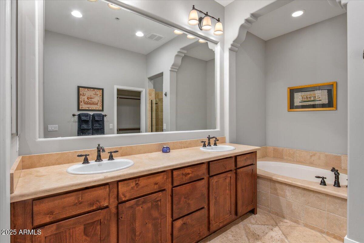 20704 North 90th Place, Unit 1004 Scottsdale, AZ 85255 - Photo 18 of 28 a bath room with a sink vanity tub and a mirror