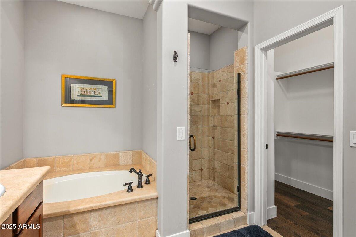20704 North 90th Place, Unit 1004 Scottsdale, AZ 85255 - Photo 19 of 28 a bathroom with a bathtub and a shower