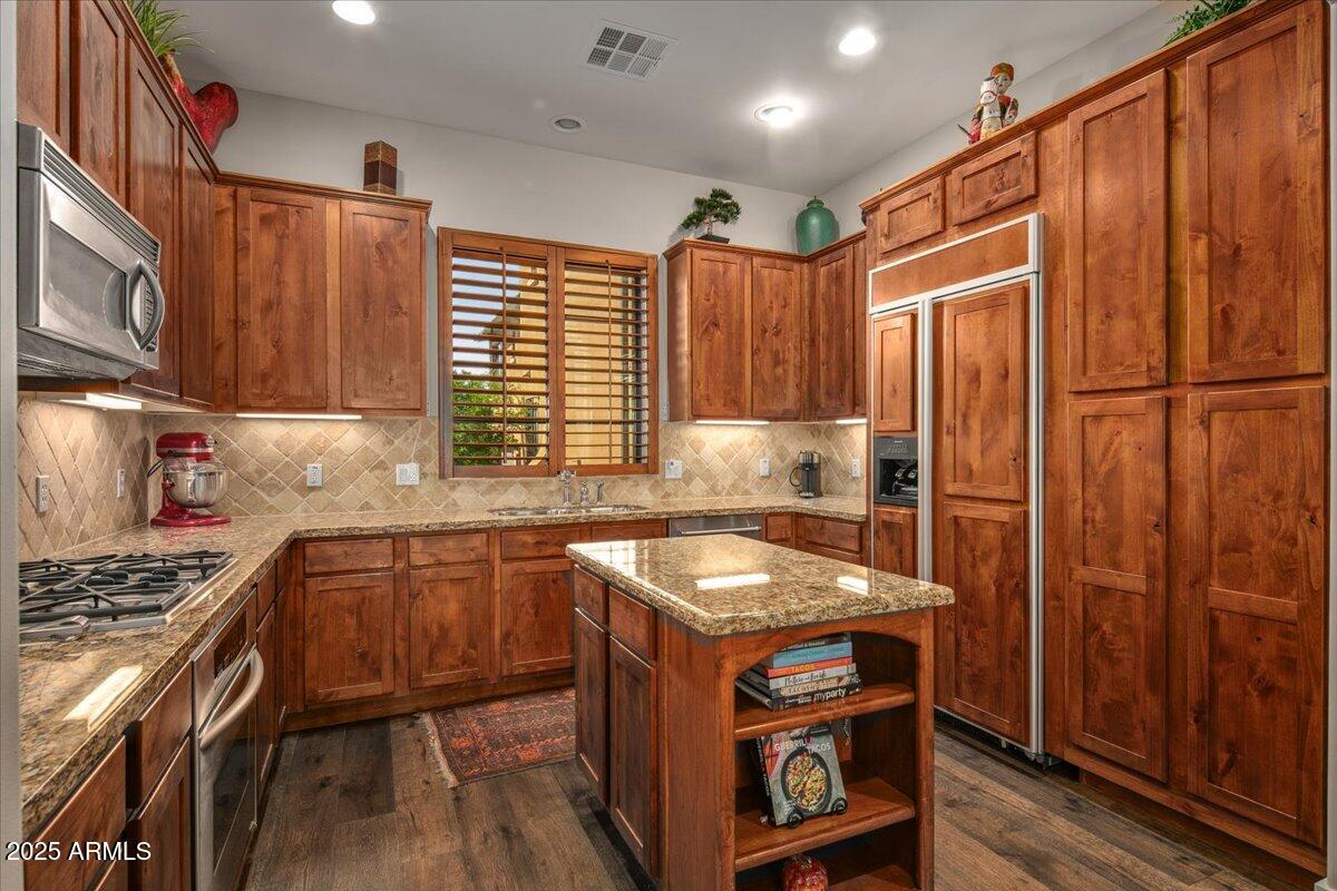 20704 North 90th Place, Unit 1004 Scottsdale, AZ 85255 - Photo 3 of 28 a kitchen with stainless steel appliances granite countertop a stove a sink and a refrigerator
