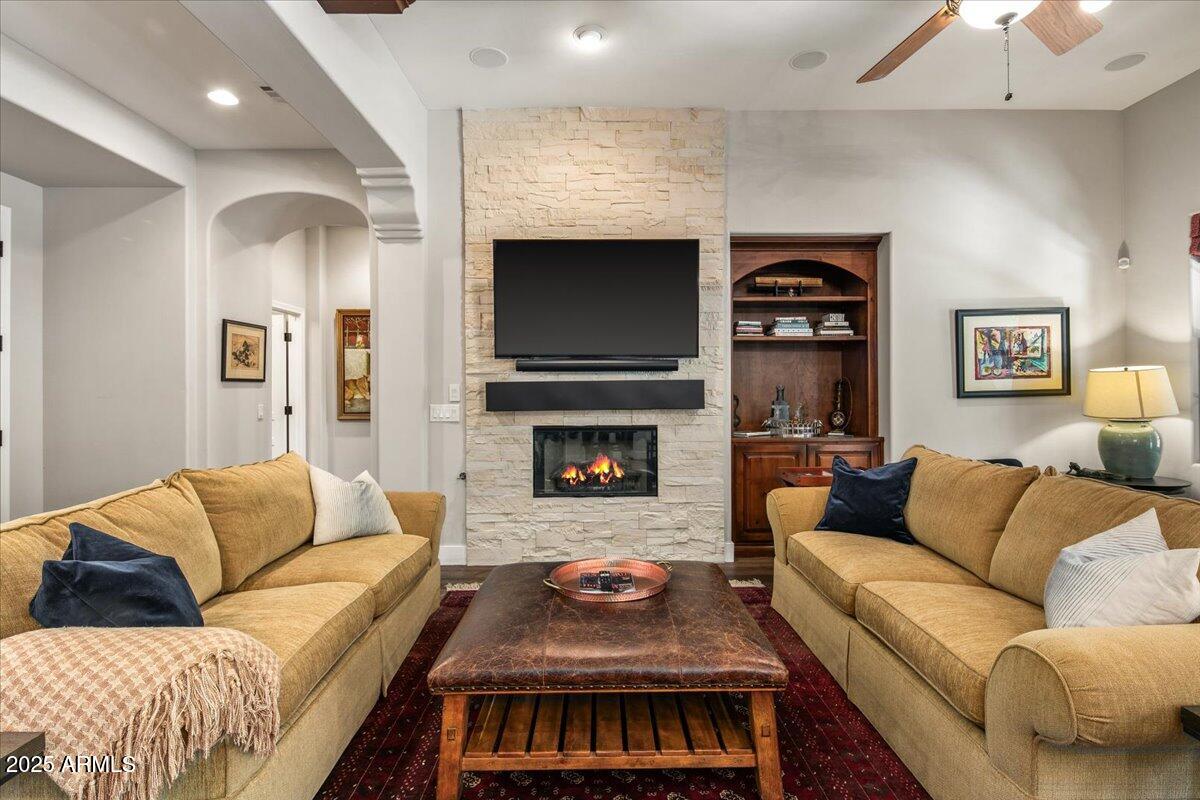 20704 North 90th Place, Unit 1004 Scottsdale, AZ 85255 - Photo 4 of 28 a living room with furniture and a fireplace