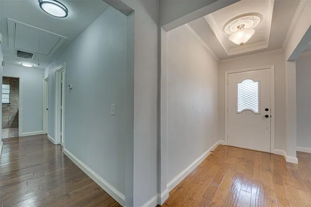 a view of a hallway with wooden floor