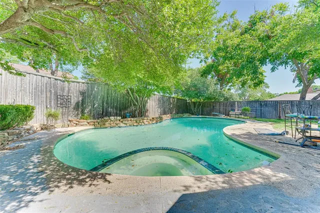 a view of a backyard with swimming pool