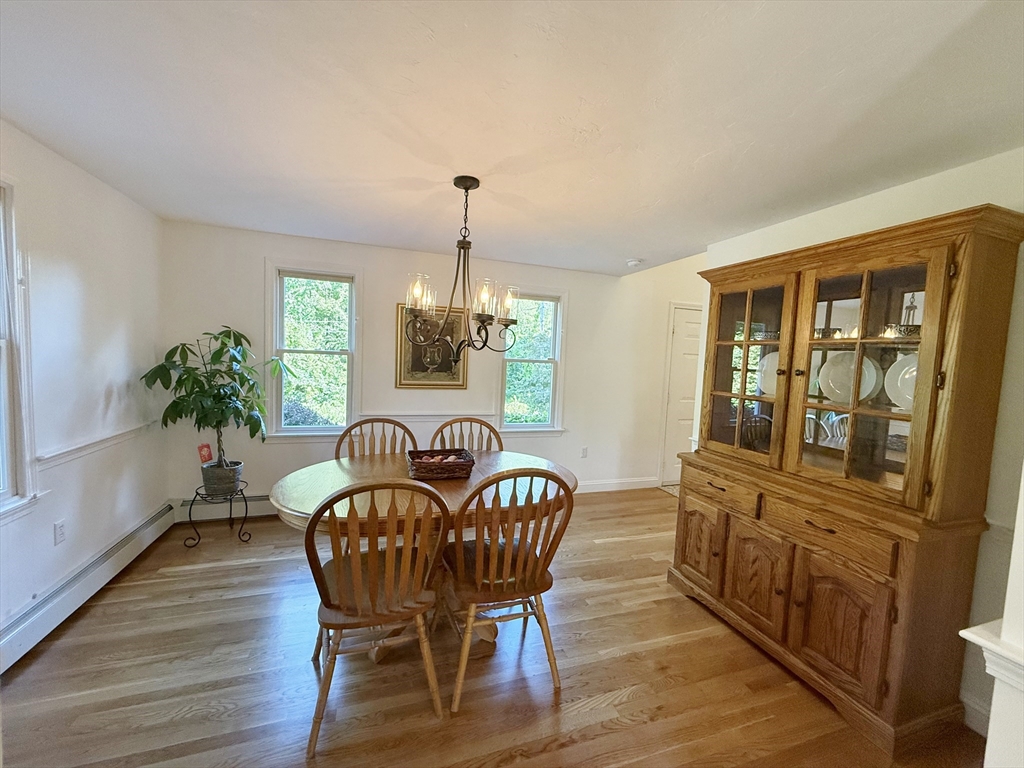 291 Harvard Road Bolton, MA 01740 - Photo 15 of 40 a view of a dining room with furniture window and wooden floor