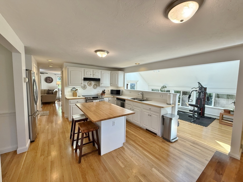 291 Harvard Road Bolton, MA 01740 - Photo 20 of 40 a large kitchen with a table and chairs in it