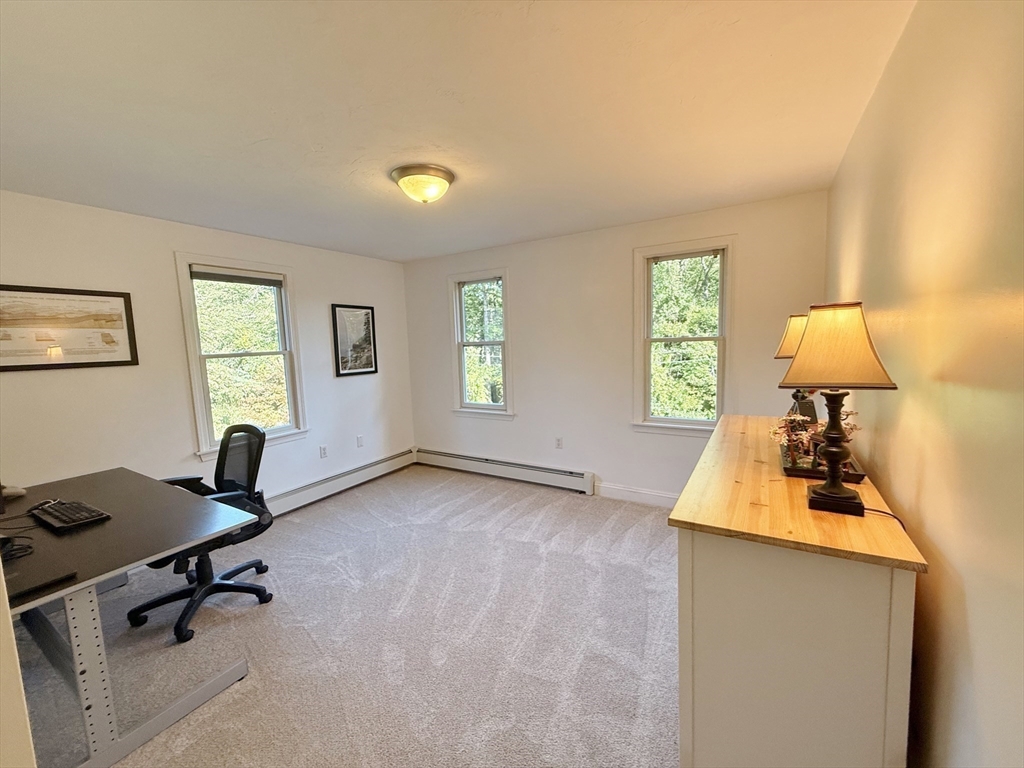 291 Harvard Road Bolton, MA 01740 - Photo 24 of 40 a view of a workspace with furniture and a window
