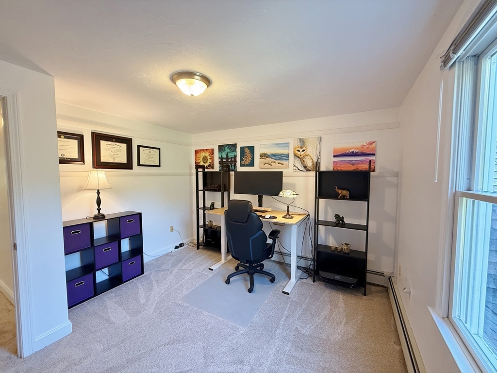291 Harvard Road Bolton, MA 01740 - Photo 25 of 40 a view of a workspace with furniture and toys