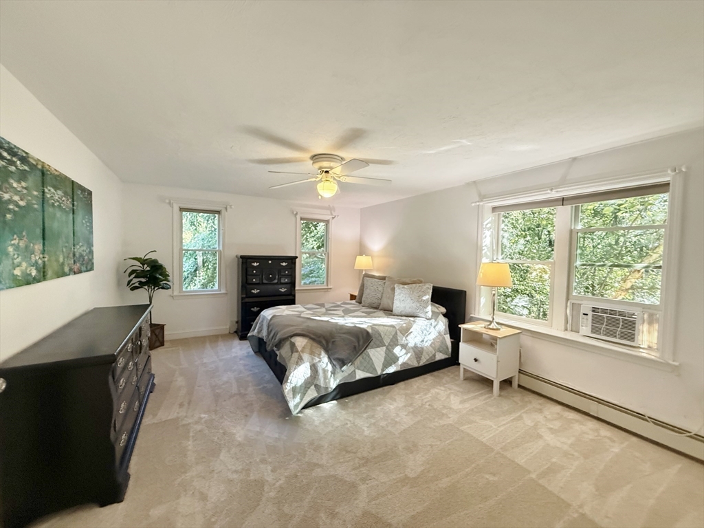 291 Harvard Road Bolton, MA 01740 - Photo 27 of 40 a spacious bedroom with a bed and window