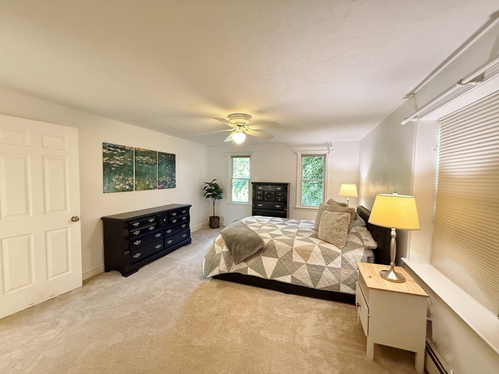 291 Harvard Road Bolton, MA 01740 - Photo 28 of 40 a spacious bedroom with a bed and a couch